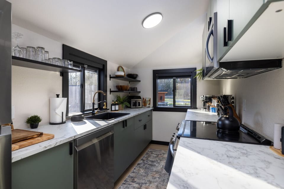 Freshly renovated and furnished kitchen with modern appliances, cookware, and generous counter space — ready for home‑cooked meals.