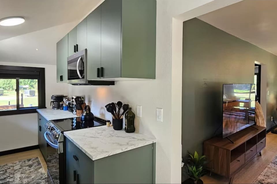 Bright, open layout where the freshly renovated kitchen flows into a cozy living space — perfect for cooking, relaxing, and entertaining.