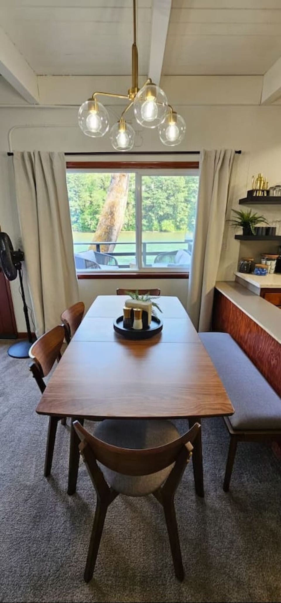 Enjoy meals around a spacious dining table with beautiful vistas of the river and trees — a peaceful spot to connect over breakfast, dinner, or a board game.
