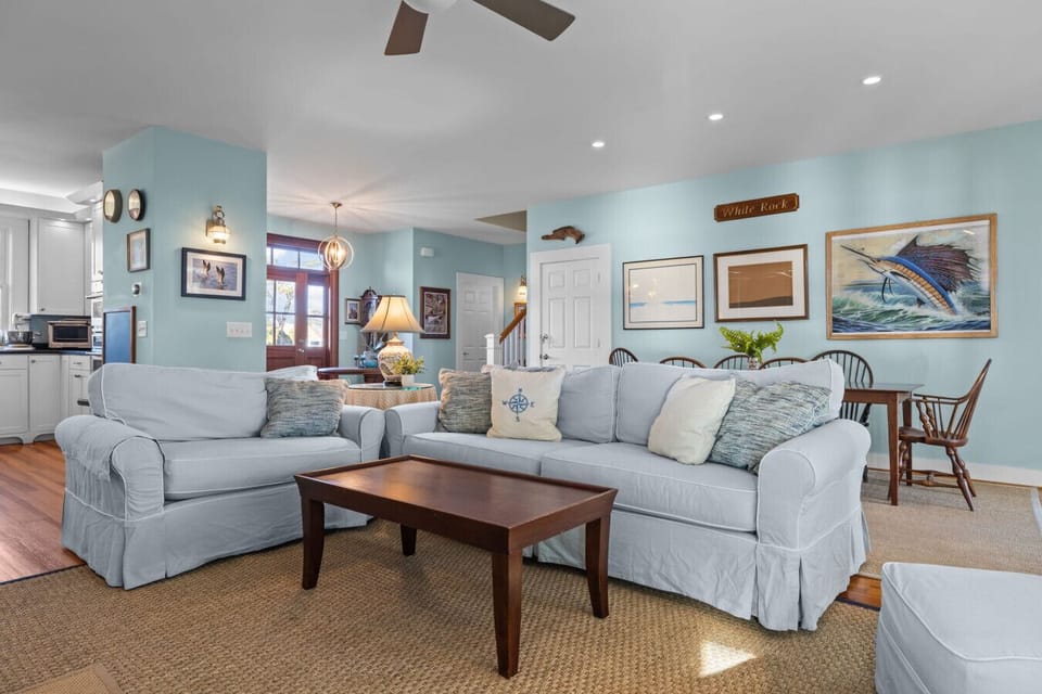 Light-filled coastal living space with plush seating and an open layout—ideal for relaxing and spending time together