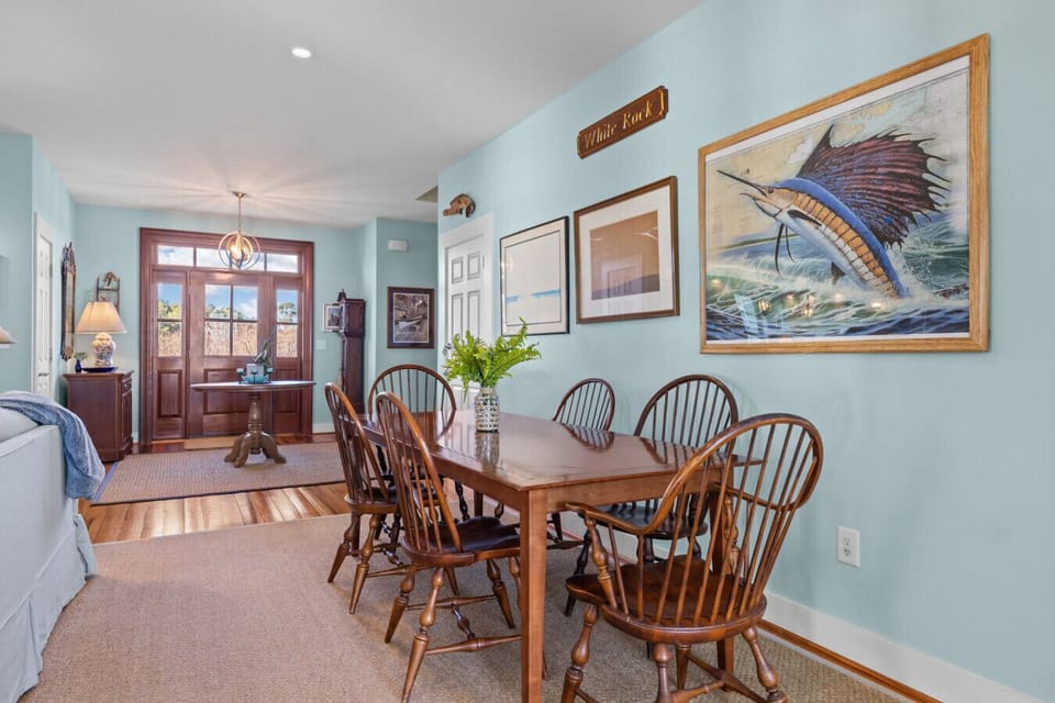 Dining area for six with coastal décor and natural light—perfect for shared meals and gathering together