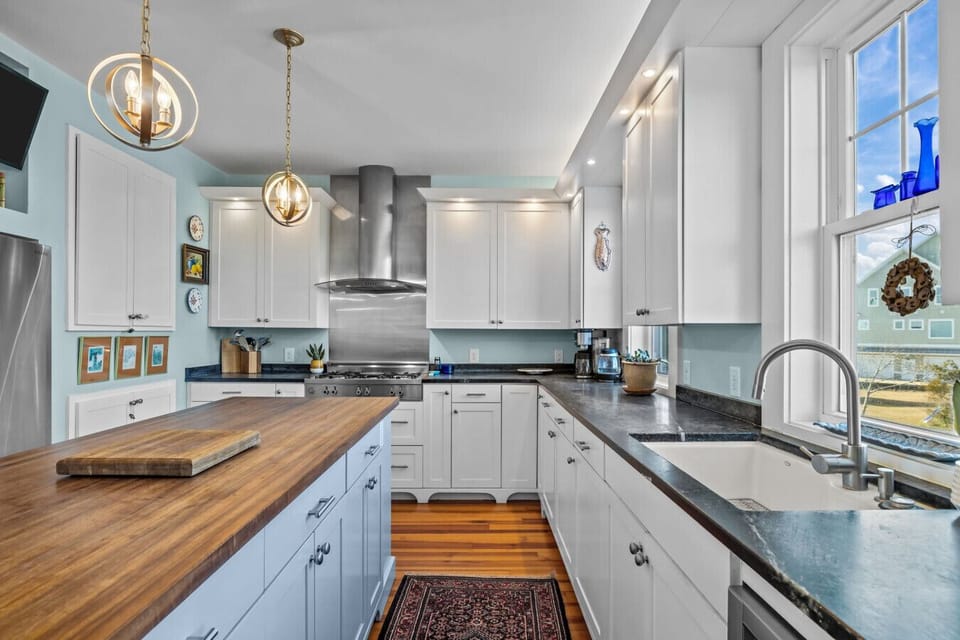 Beautiful gourmet kitchen featuring a large island, modern appliances, and generous workspace—ideal for meals and entertaining