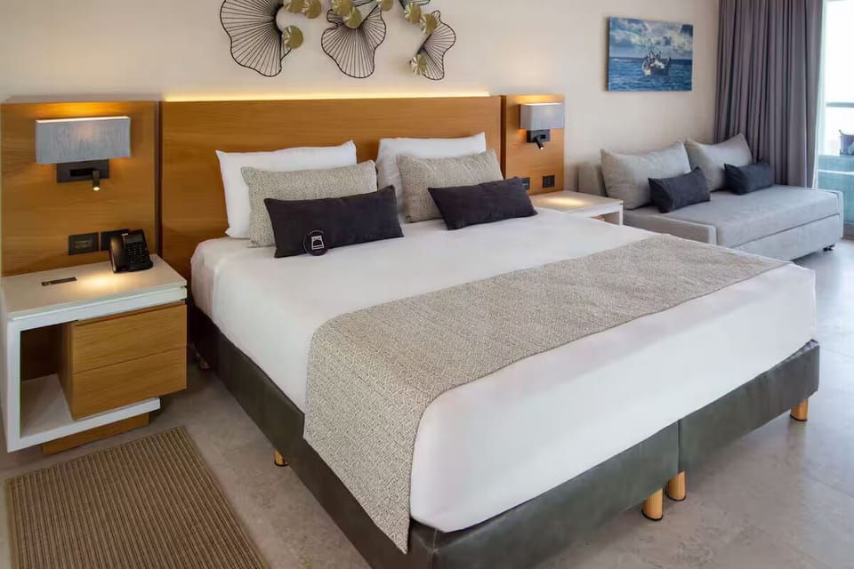 The room has a King size bed, along with a sofa.
