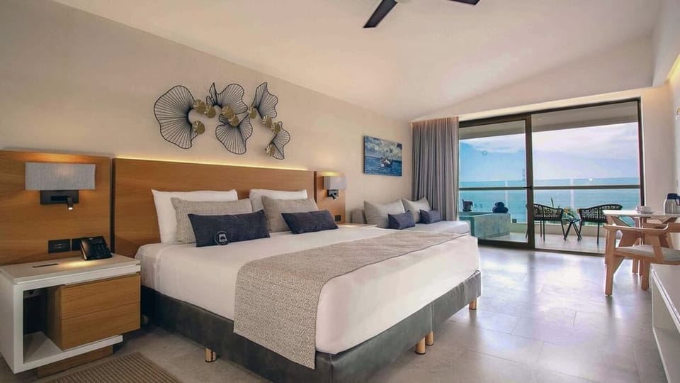 The room has a King size bed, along with a sofa.