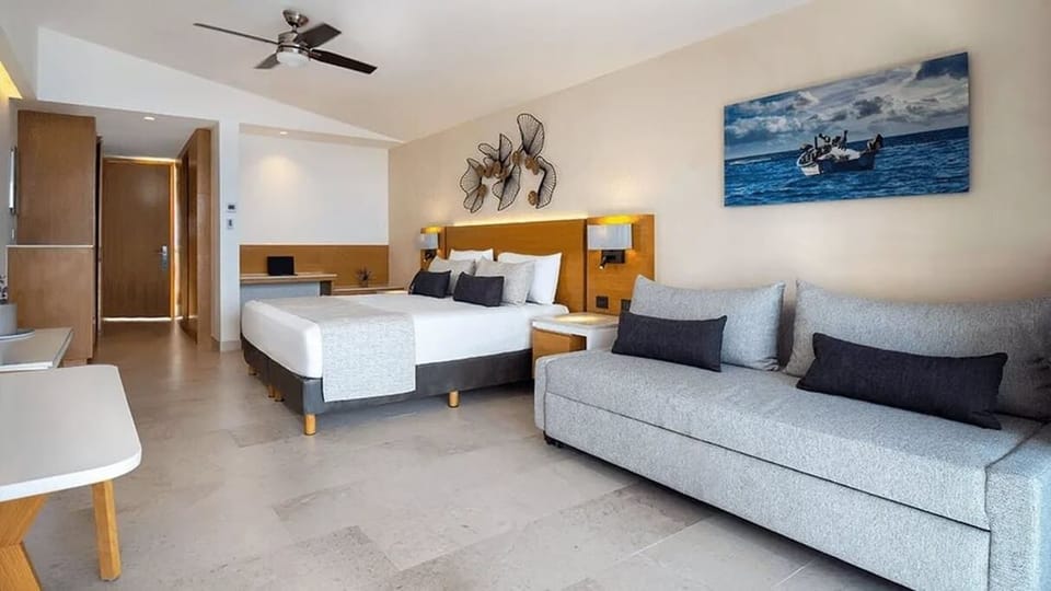 The room has a King size bed, along with a sofa.