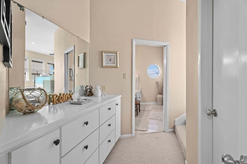 Spacious bedroom with dresser storage and en-suite access, ideal for extended stays.