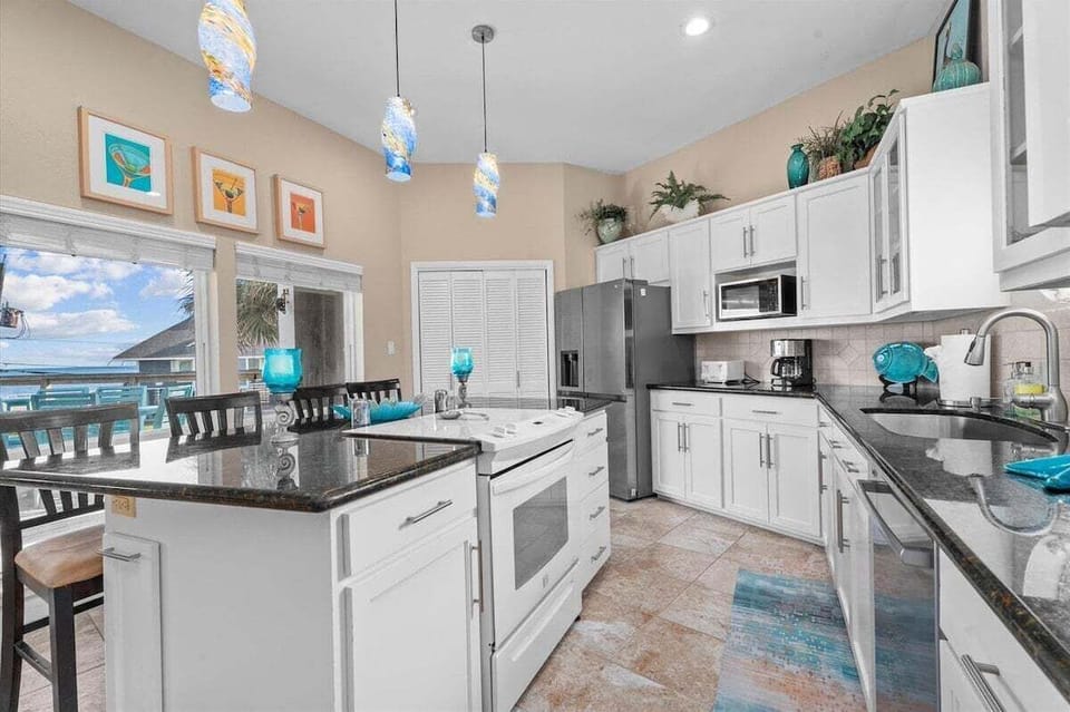 Bright kitchen with ample counter space, custom cabinetry, and stylish décor for cooking and entertaining.