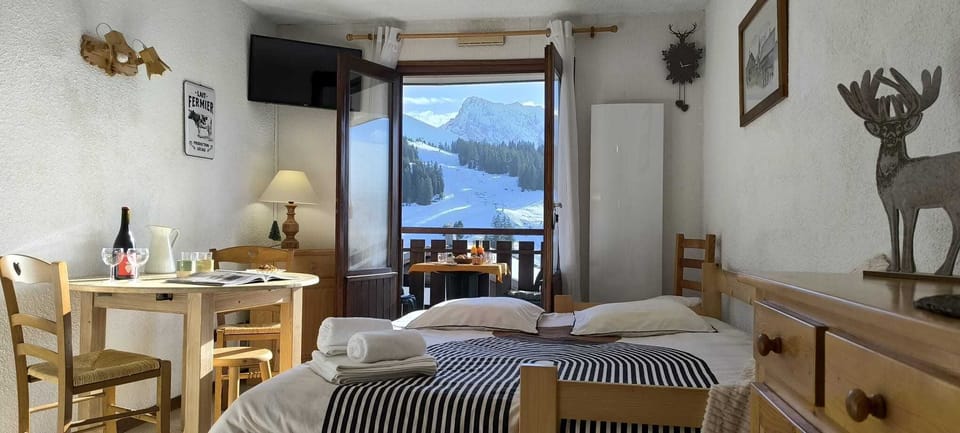 sofa bed, dining area , balcony mountain view