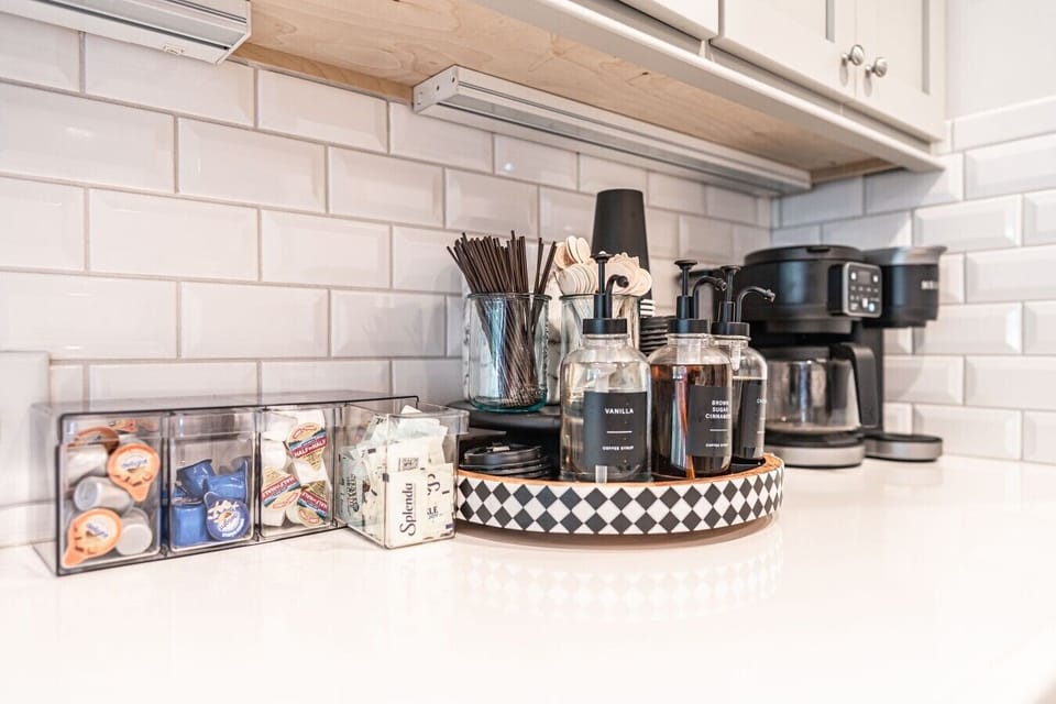 Well-appointed kitchen counter with coffee station, beverages, and convenient cooking essentials.