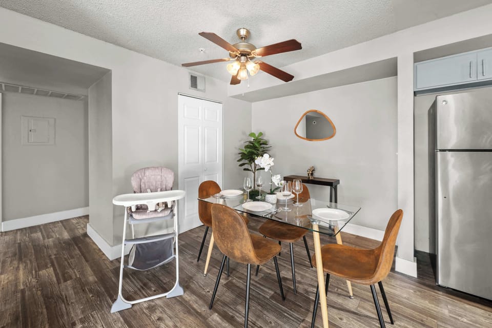 Elegant dining area with seating for four, plus a high chair for added convenience.
