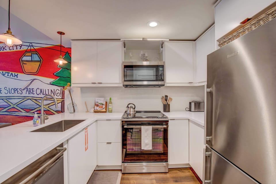 Kitchen with microwave, cooking range, oven, dish washer and refrigerator