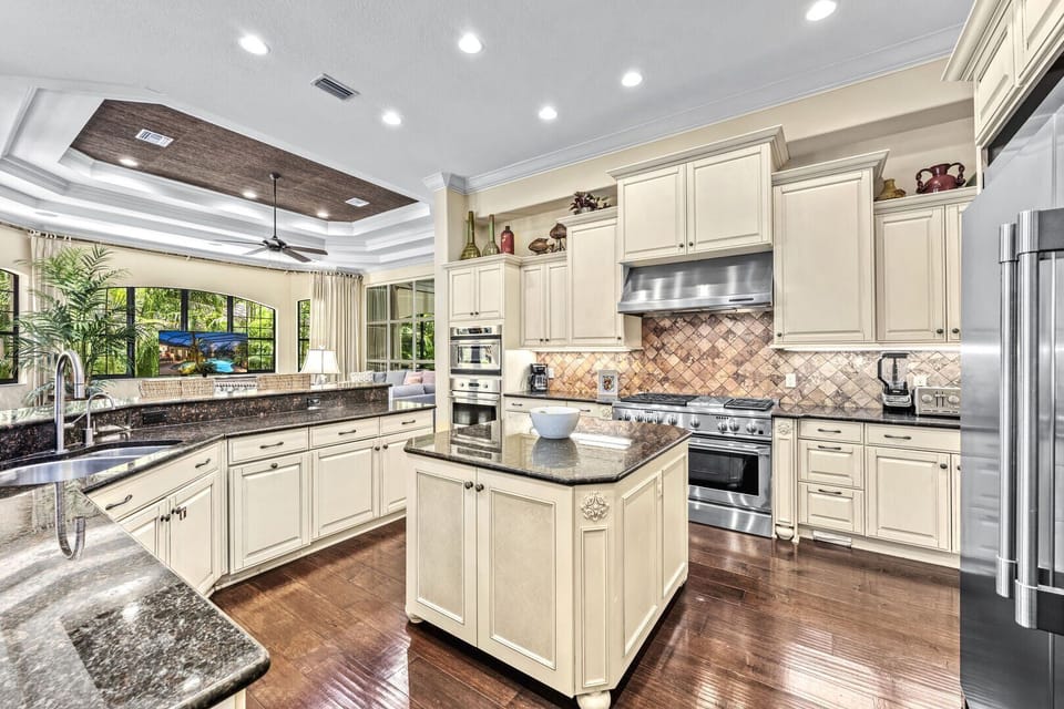 A spacious kitchen with a central island and full suite of appliances.