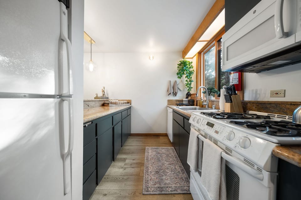 A galley style kitchen maximizes the space and features a gas stove