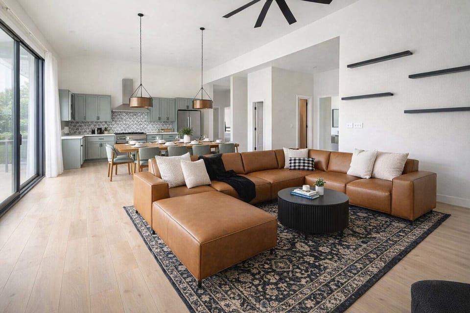 {Great Room} Anchored by a luxe leather sectional, dining for 12, and a fully equipped chef’s kitchen, Summit’s great room was designed for connection.