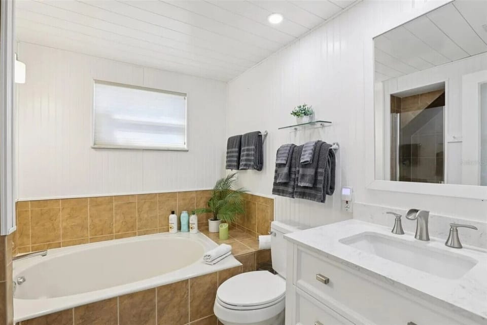upstairs bathroom with tub and shower
