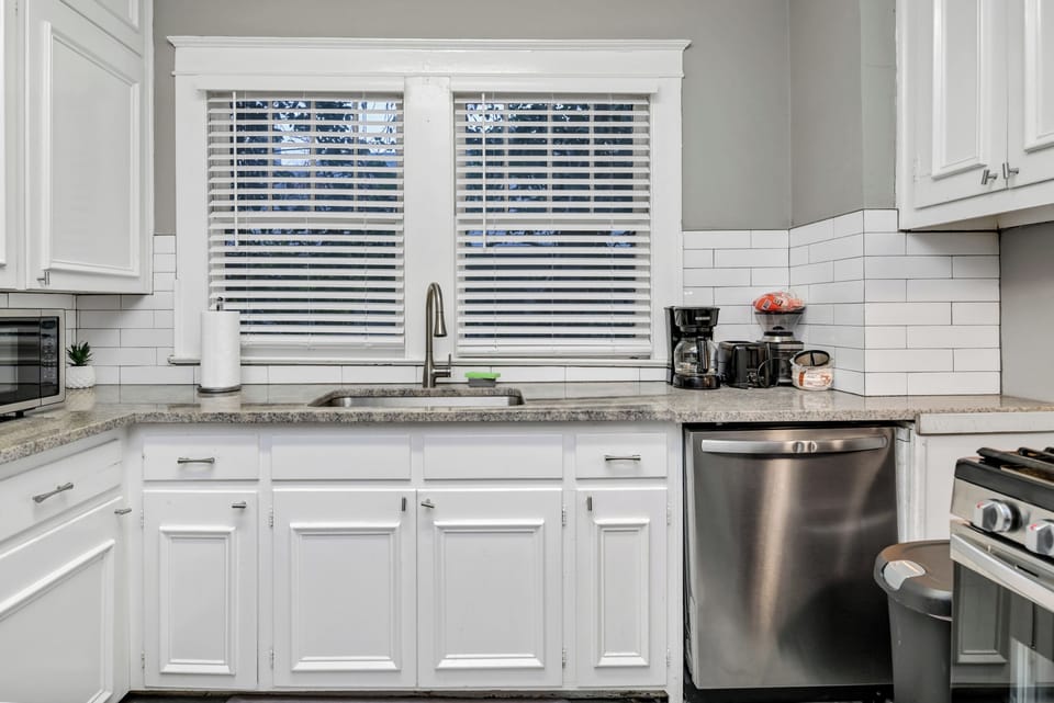 Bright modern kitchen with stainless appliances and sunny window views