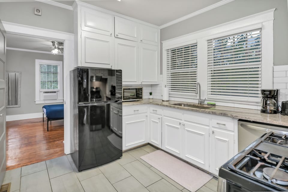 Bright updated kitchen with stainless appliances and sunny window views