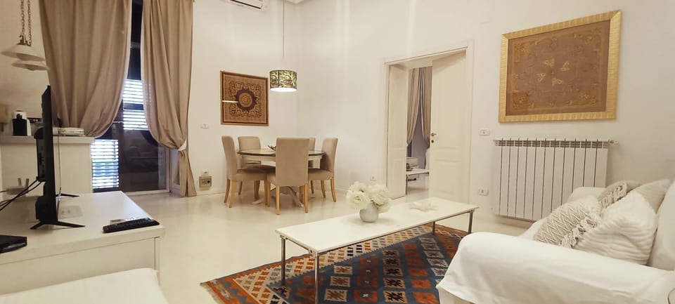 Deluxe Suite, Balcony, City View | Living area | TV