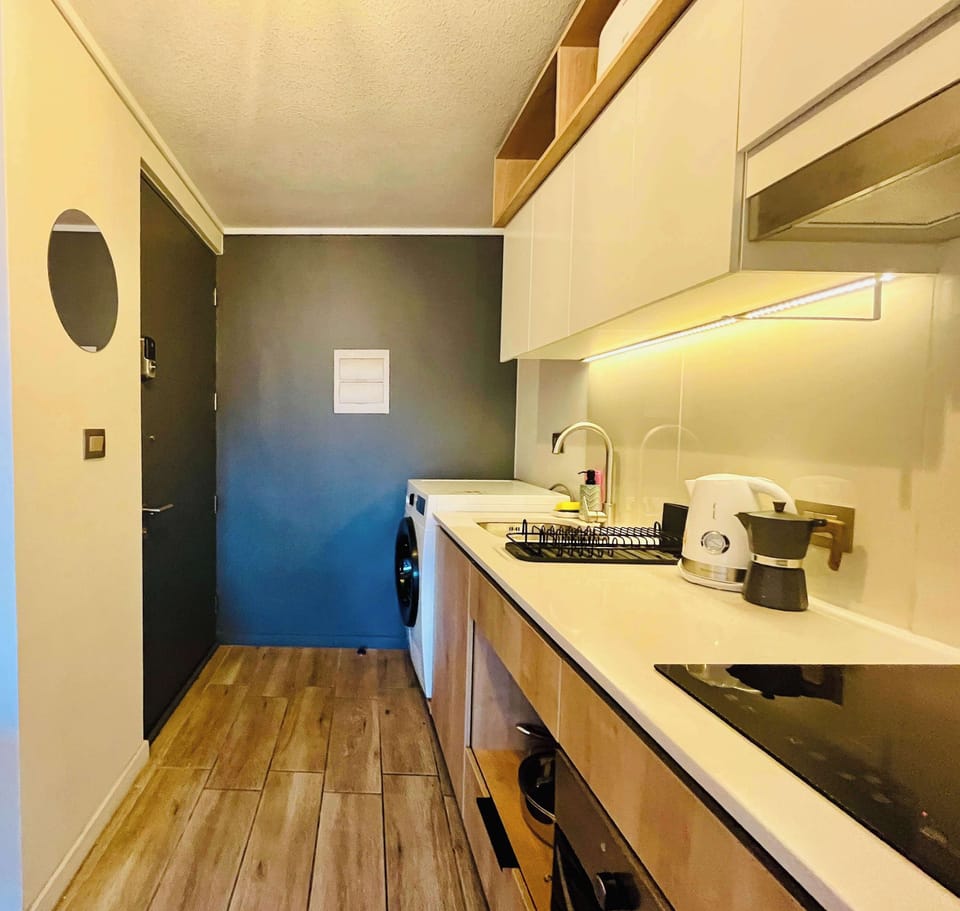 Contemporary kitchen w/ streamlined cabinets & generous counter space for meal prep.