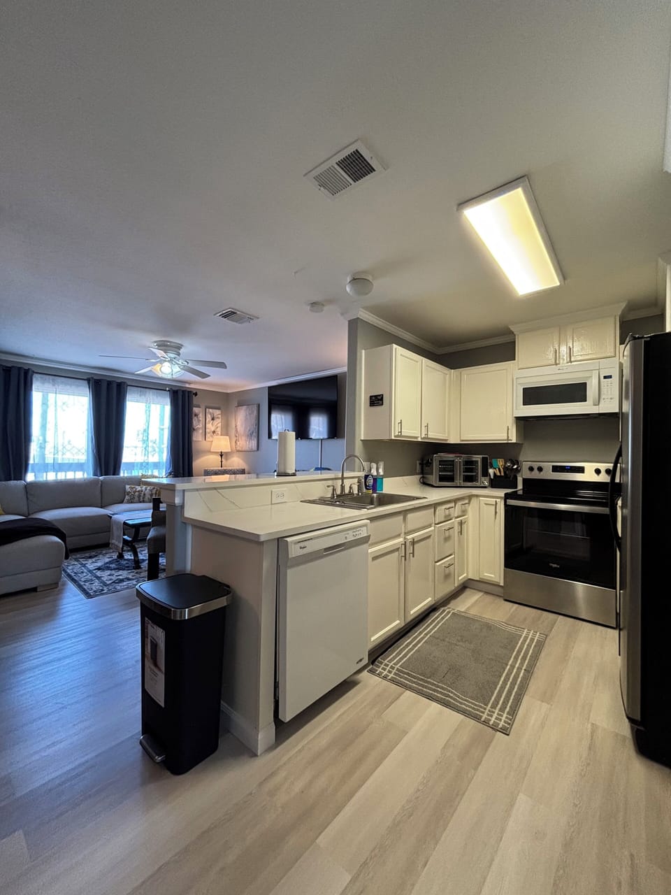 Kitchen with view of living room and dinning area.