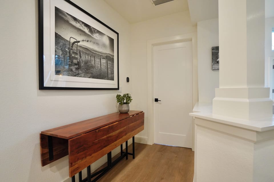 Curated local artwork paired with a handcrafted origami table.