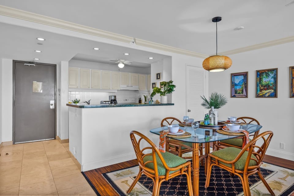 Enjoy a welcoming dining area that blends natural textures and coastal accents with an open layout leading into the bright kitchen.
