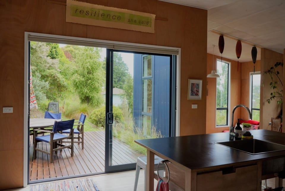 The kitchen has beautiful light and direct access onto deck