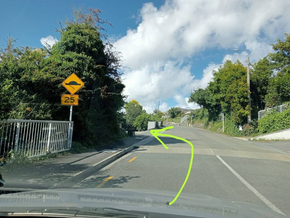 Turn directly left on the first speed hump and park there! Room for 2 cars.