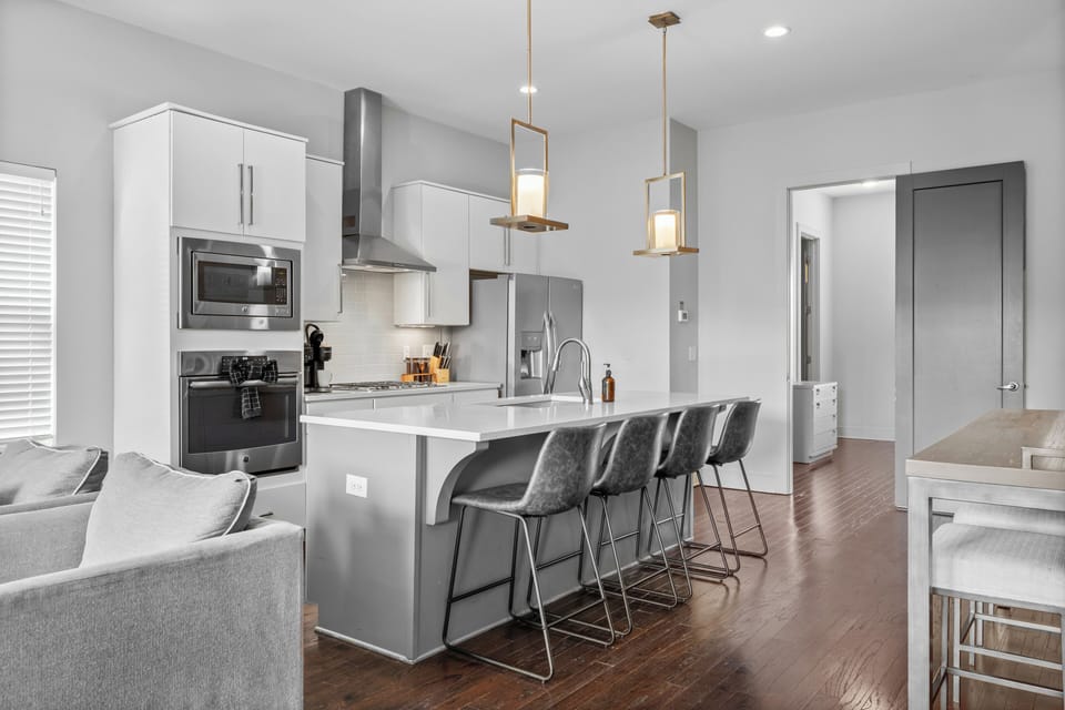 Comfy bar seating. Pendants placed perfectly to warm the space without glare.