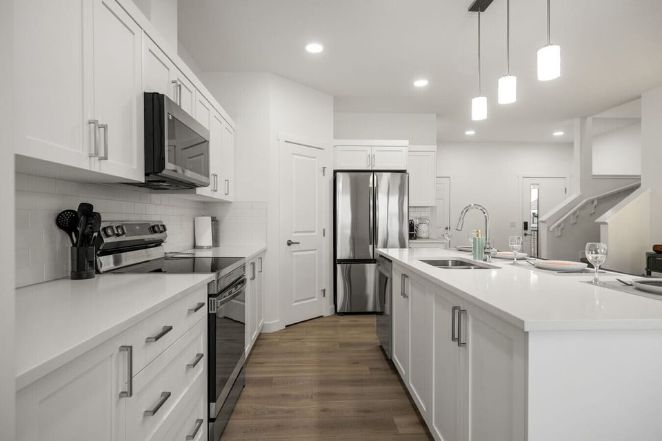 Fully equipped kitchen with stainless steel appliances and large island workspace