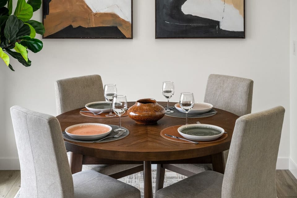 Elegant round dining table seating four with contemporary place settings