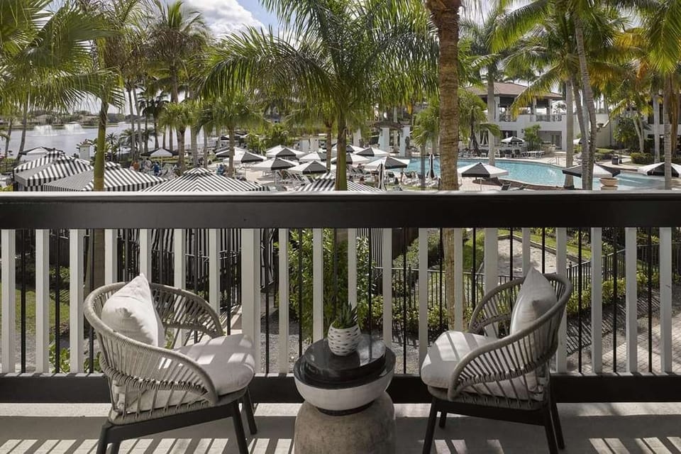 Sip morning coffee overlooking palms, cabanas, and sparkling pool views.