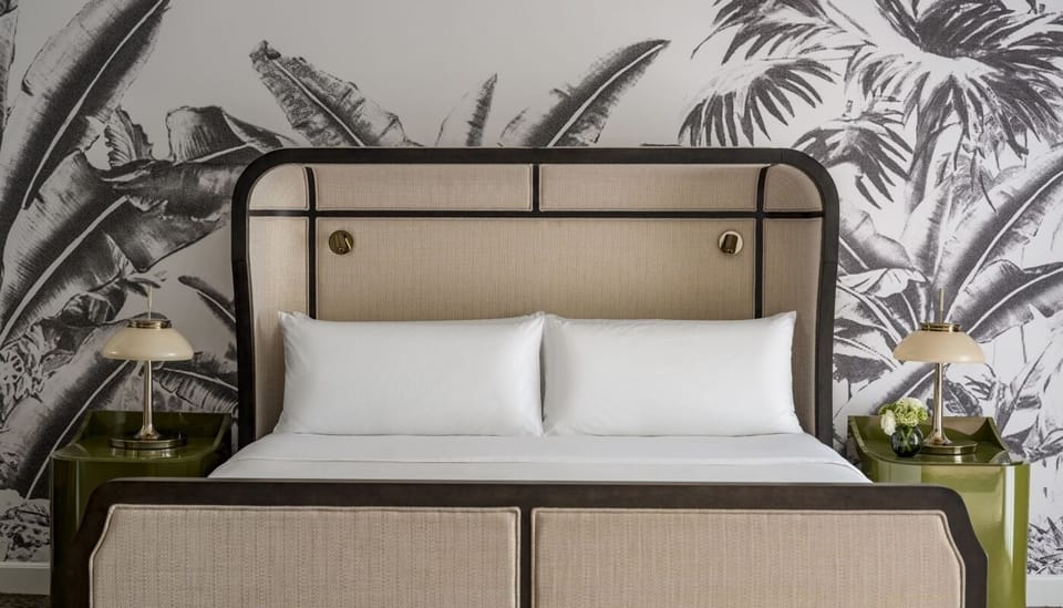 Drift off beneath crisp linens and a statement headboard.