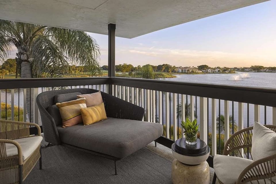 Sip morning coffee on the balcony overlooking serene water views.