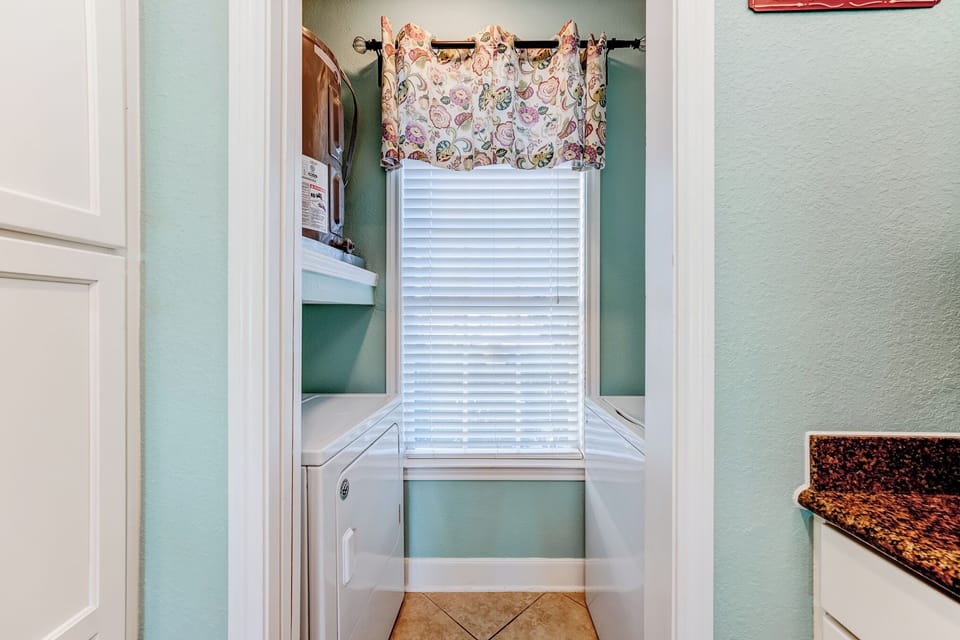 Washer & dryer in condo off of the kitchen.