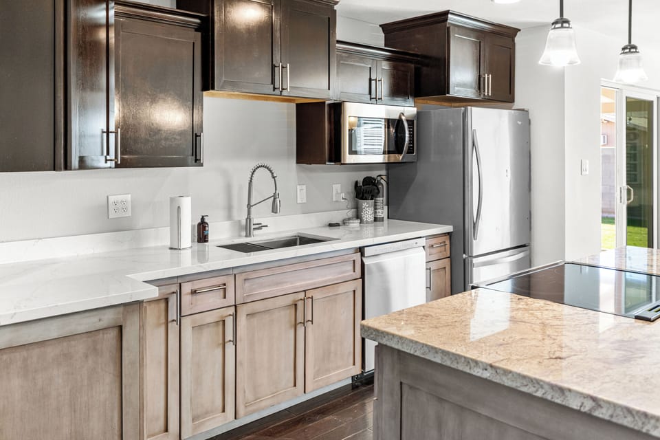 Cook your favorite meals in this modern kitchen featuring granite counters, stainless appliances, and everything you need for comfortable stays.