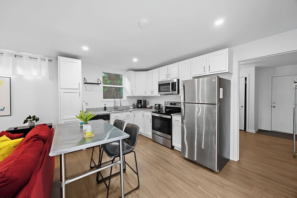 Open concept kitchen and dining area with stainless steel appliances.