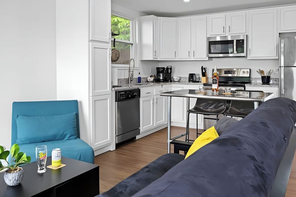 Relax in style on the comfy sofa in this bright open concept living area.