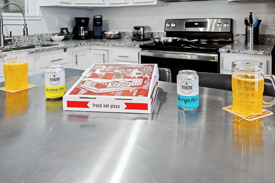 The stainless steel kitchen island is the perfect spot for a casual pizza night.