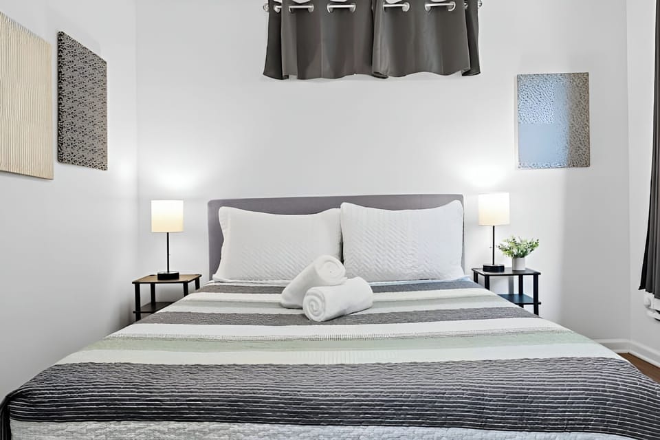 Enjoy a restful sleep in a bed made with soft linens and comfy pillows.