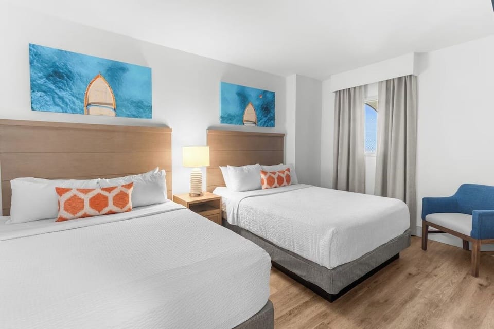 Unwind on crisp linens in a bright, airy double-queen room.