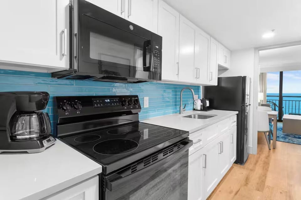 Cook beach-day favorites in the bright kitchen with full appliances.