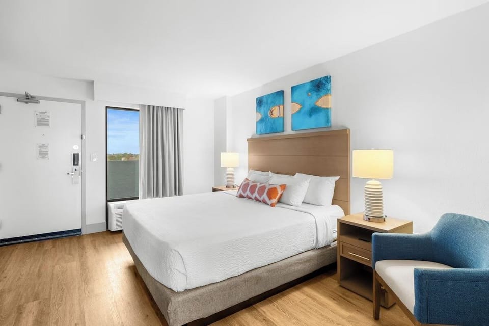Sink into crisp linens in your bright, modern coastal room.