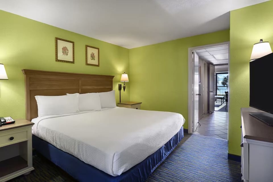 Unwind in a cozy king bed after sunny beach days.