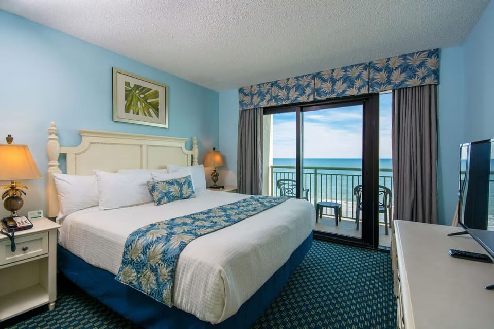 Drift off in a cozy guest room with soft coastal colors.