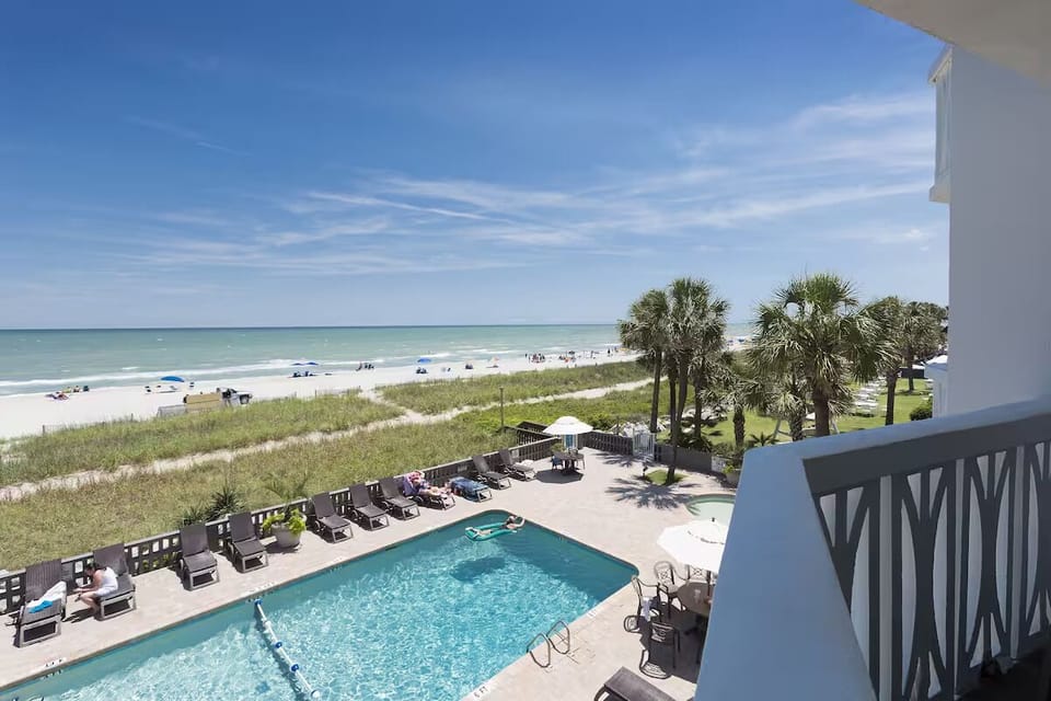 Soak up sunshine poolside steps from the beach.