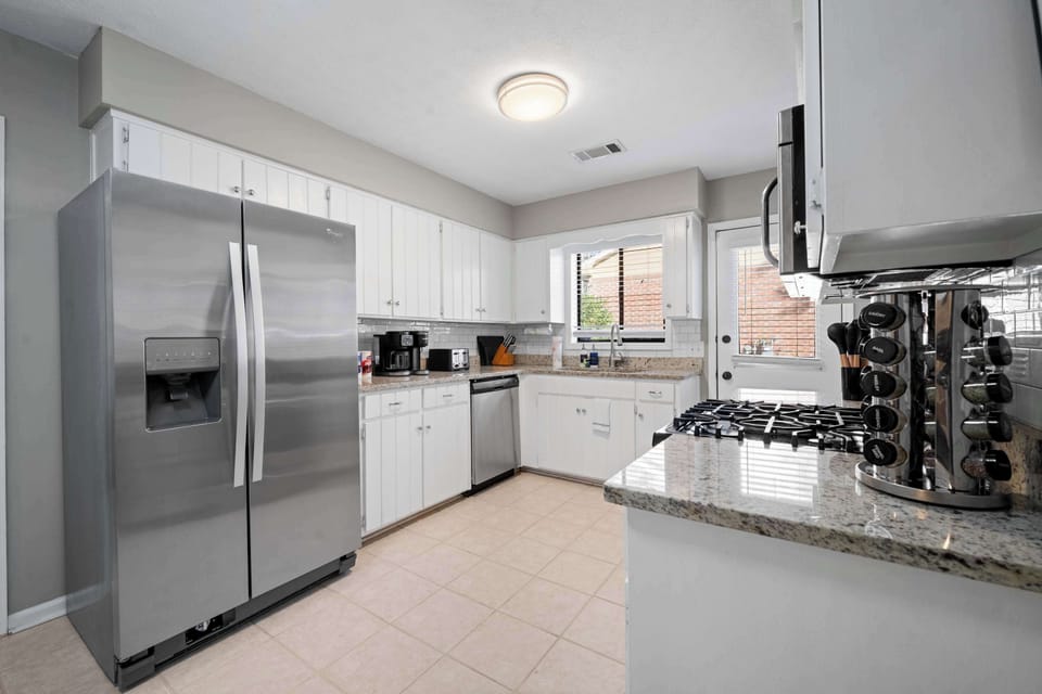 Spacious kitchen with full-size fridge and ample storage
