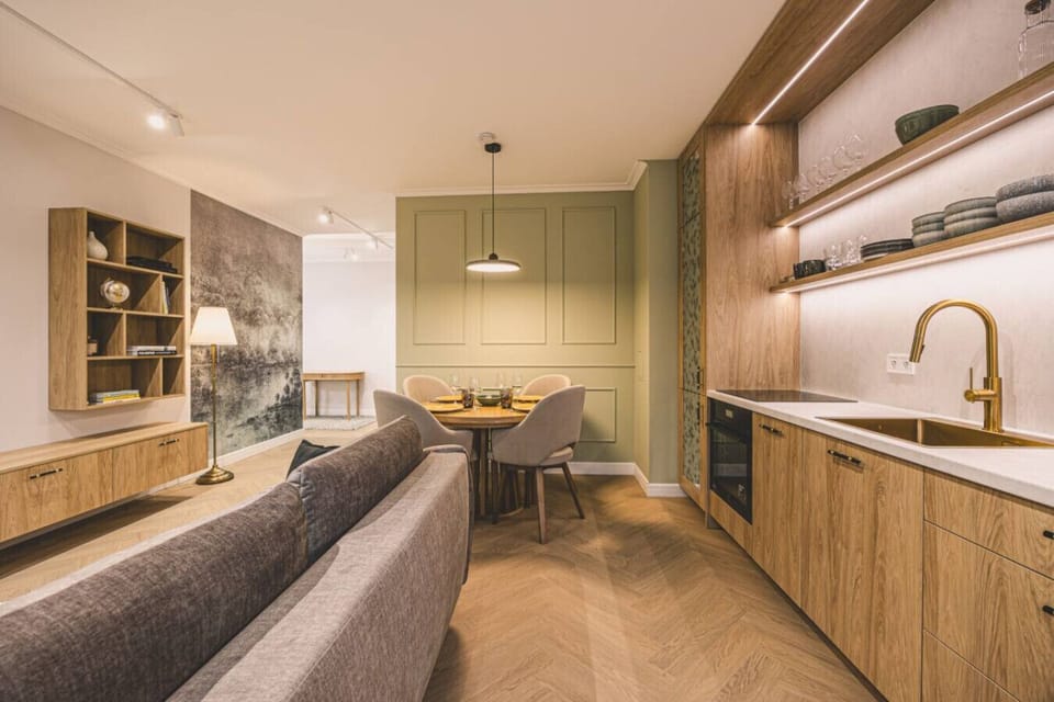 Modern wood-finished kitchen with dining area – perfect for shared meals in the heart of the city.