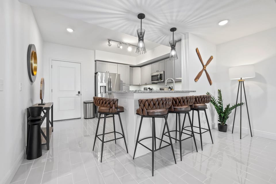 Modern kitchen with a granite countertop bar and leather braided stools