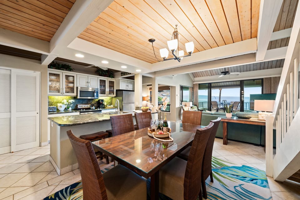 Enjoy meals in this bright dining area featuring tropical decor and a backdrop of blue waters
